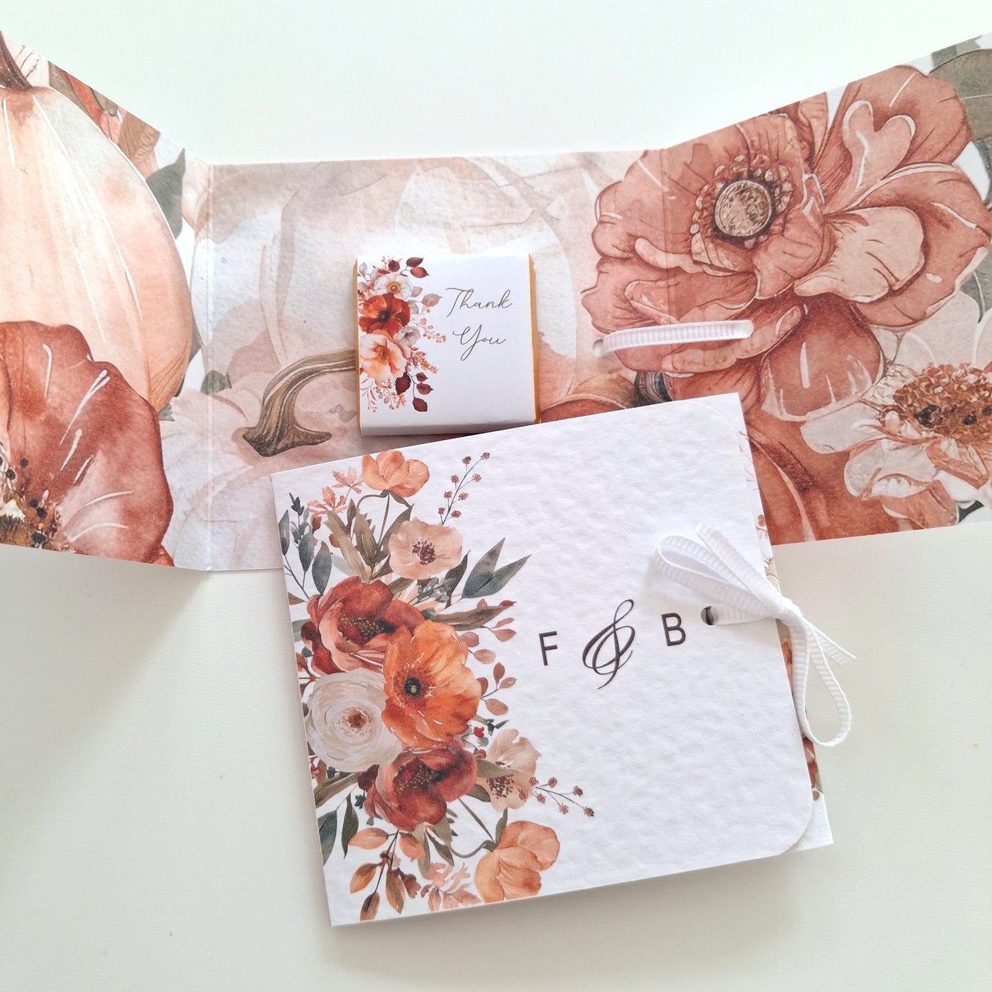 Personalized  favour with a ribbon and a thank you chocolate featuring an autumn floral design.
