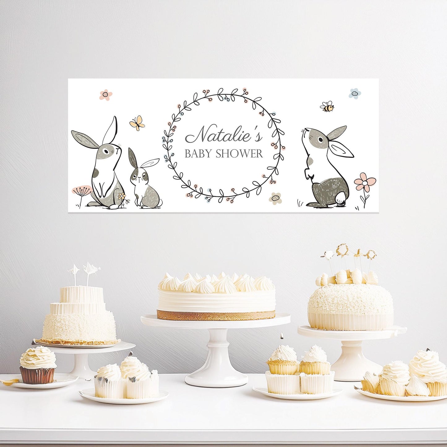 A personalized banner with a floral wreath and rabbit design, printed on premium satin paper. It's intended for a woodland-themed baby shower.