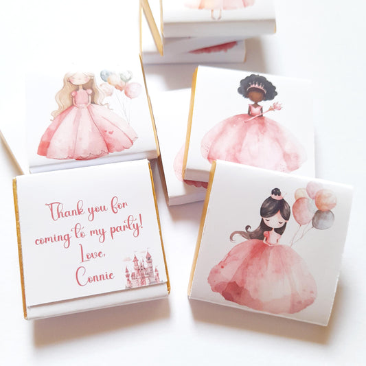 Princesses chocolate favour – square Fairtrade milk chocolate (approx 3 cm × 3 cm, 5 g) wrapped in gold foil and glossy paper featuring a pink princesses illustrations, personalised message on the back, pack of 25