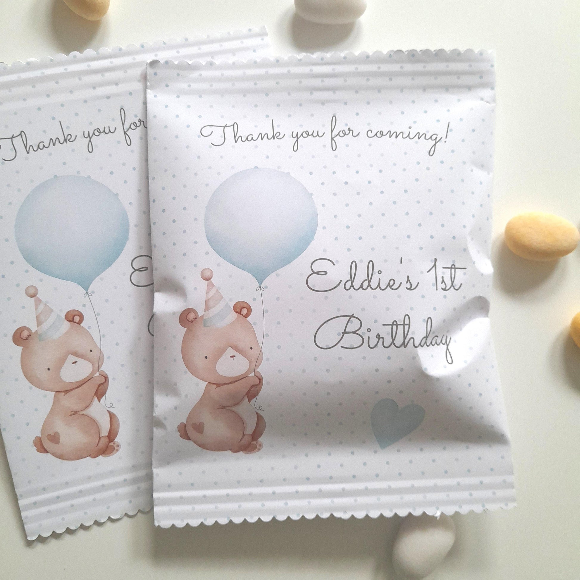 Baby 1st birthday favour bag with cute teddy bear holding blue balloon, blue polka-dot design, scalloped top edge, personalised with baby’s name and ‘Thank you for coming!’ message