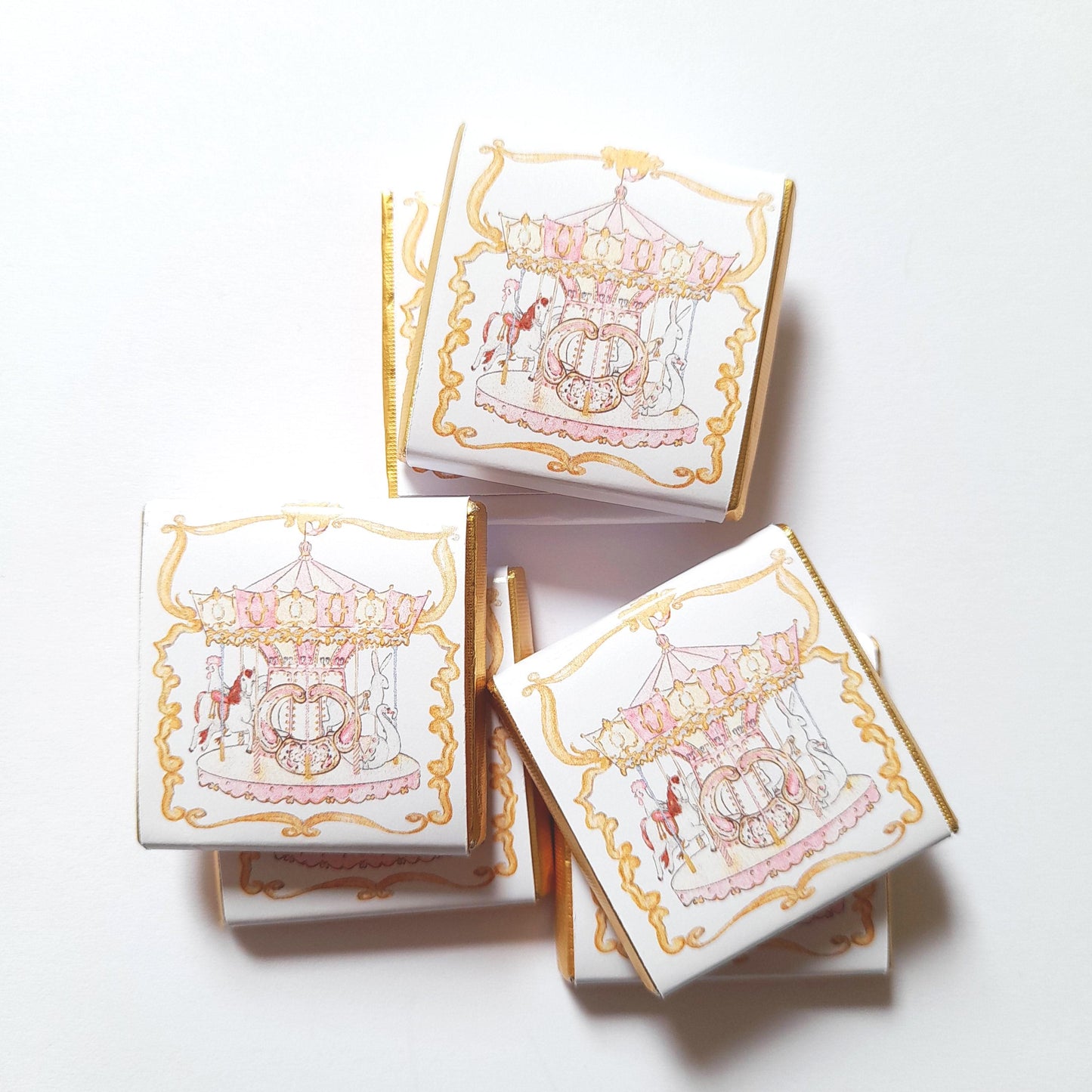 elegant pink carousel chocolate favours with "vintage charm."