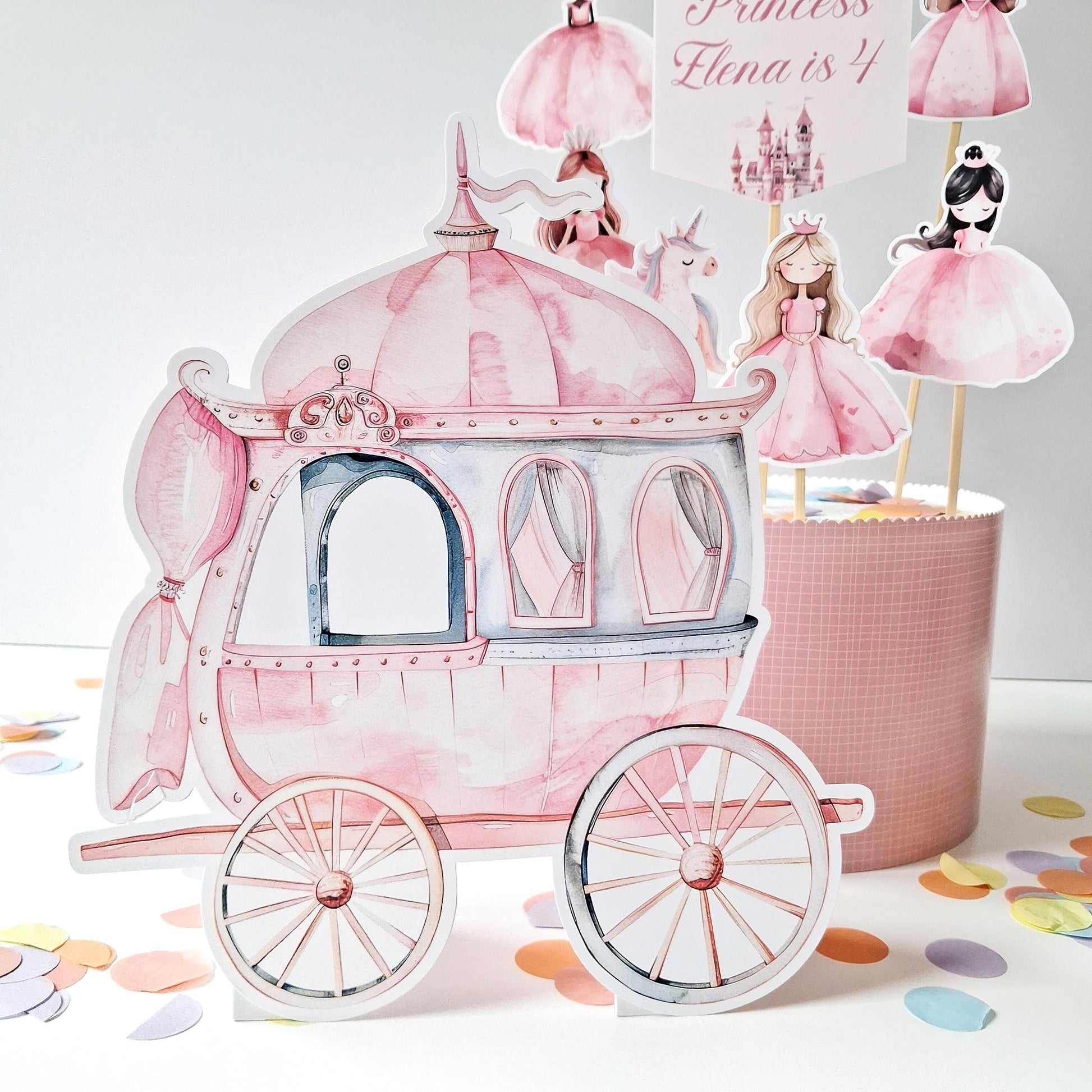 This is a handmade-in-the-UK cake topper set that includes a carriage, a unicorn, and princess figurines. It also comes with a personalised name and age topper, making it suitable for birthday celebrations.