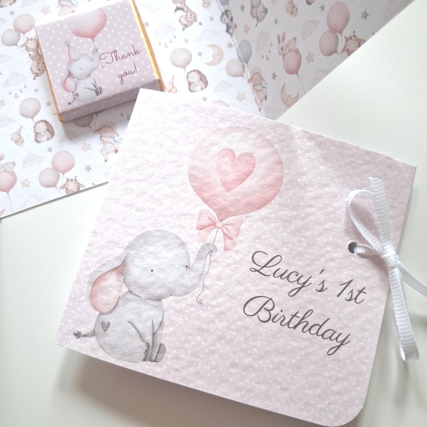 Adorable chocolate party gifts featuring a pink elephant design and handmade with a ribbon. They can be filled with either milk or vegan chocolate.