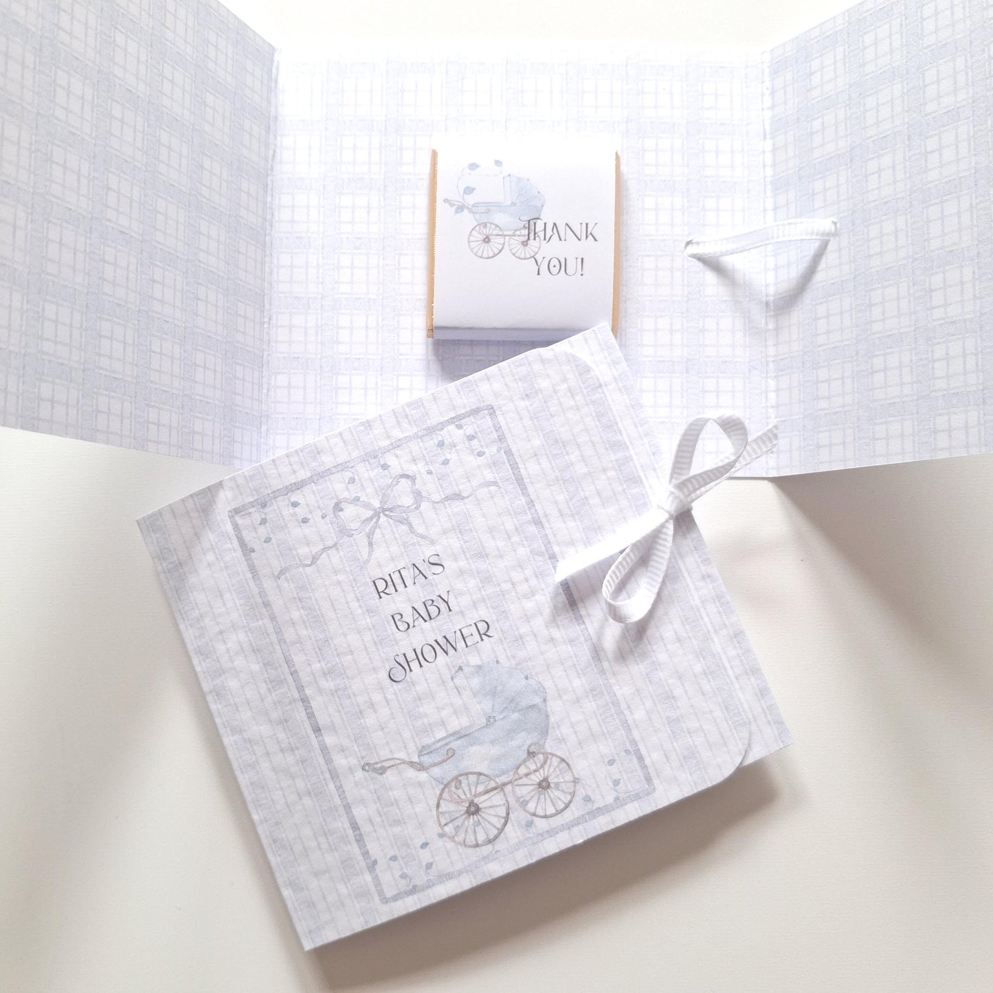 Soft blue chocolate thank-you treats, handmade with a ribbon tie and containing a mini chocolate inside. They are suitable for baby showers, christenings, and first birthdays.