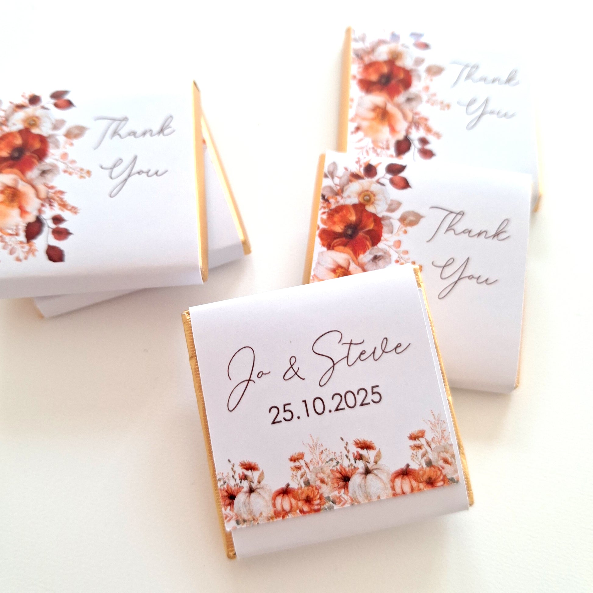 Chocolates with personalized labels featuring an autumn floral design.