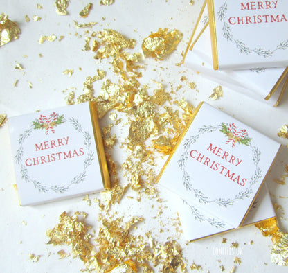 A pack of 25 chocolate favours with a festive wreath design. They are customisable on the back and say "Merry Christmas" on the front.
 Ideal for party decor, tables, or stocking treats.