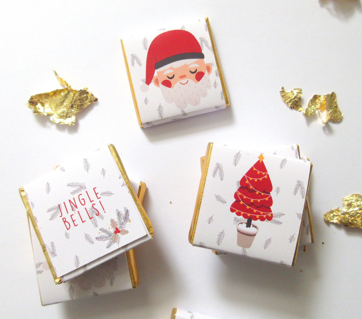 A pack of 25 personalised mini chocolates with festive designs. The chocolates have custom backs, which are perfect for use as stocking fillers, advent calendar treats, or holiday table decorations