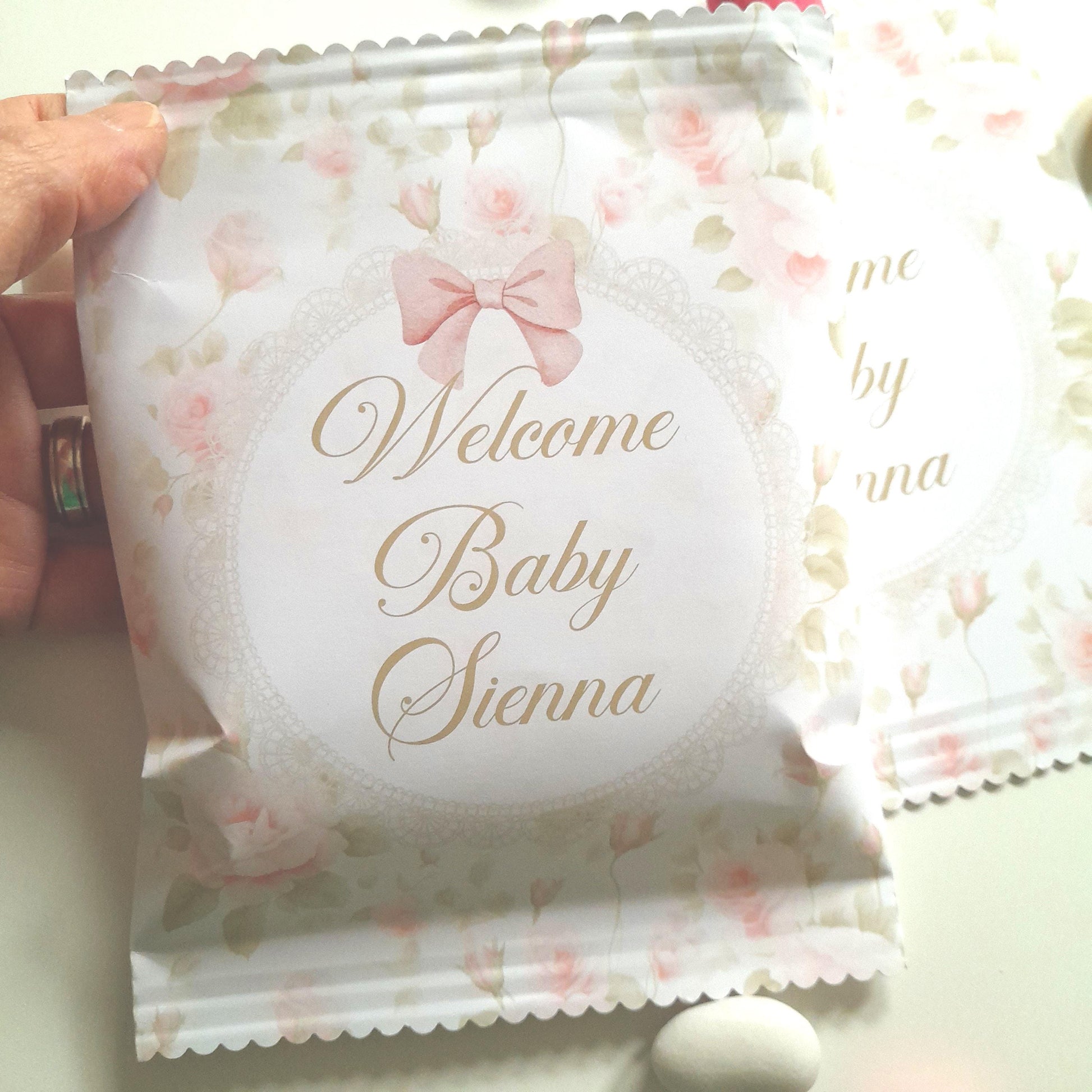Personalised ‘Welcome Baby’ floral treat bag for baby girl – matte-finish paper bag with delicate pink flowers and custom baby name, self-sealable, approx 13 cm × 17 cm