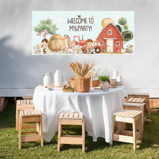 Party setup with a barn-themed backdrop and table decorations outdoors.