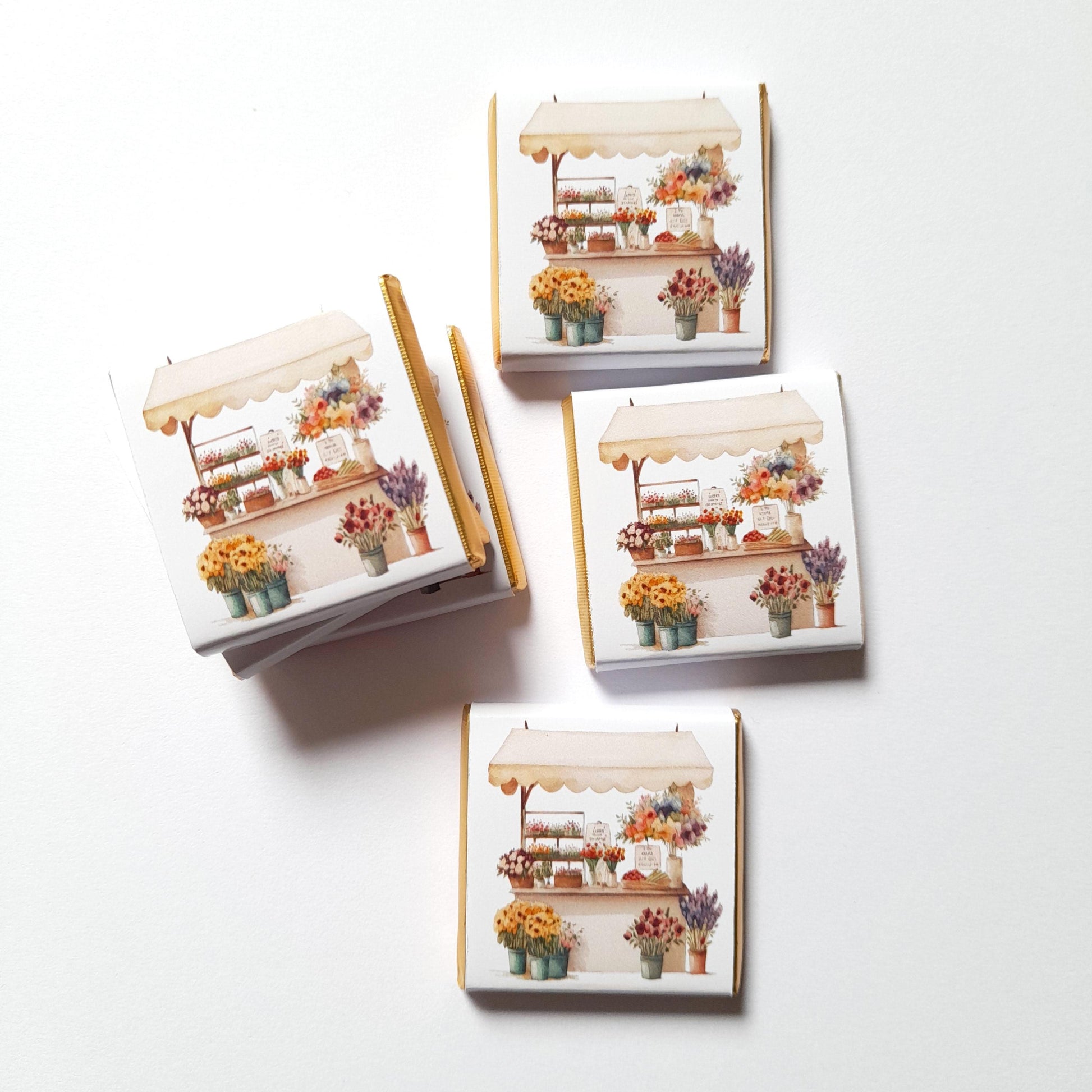 Set of small chocolates with floral market stall design on a white background