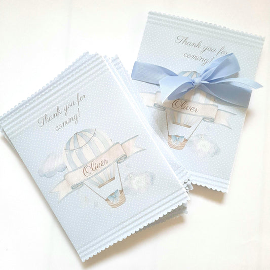 Personalised blue hot air balloon party bags designed for various events like baby showers, birthdays, or christenings. They are sold in a pack of 10 and are suitable for holding small items such as sweets, chocolates, or small gifts