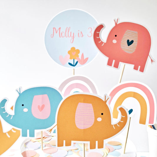 Personalised Rainbow Elephant Cake Topper Set . Handmade in the UK.
Includes a personalized name and age topper.

    Comes with a coordinating figure.