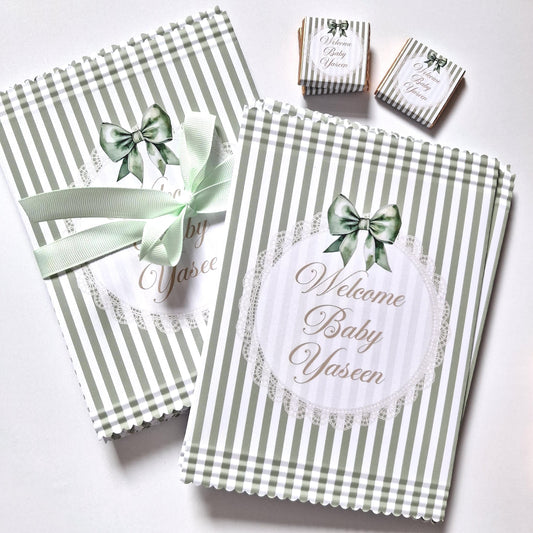 Personalised sage green paper bags with "Welcome Baby" and the baby's name.