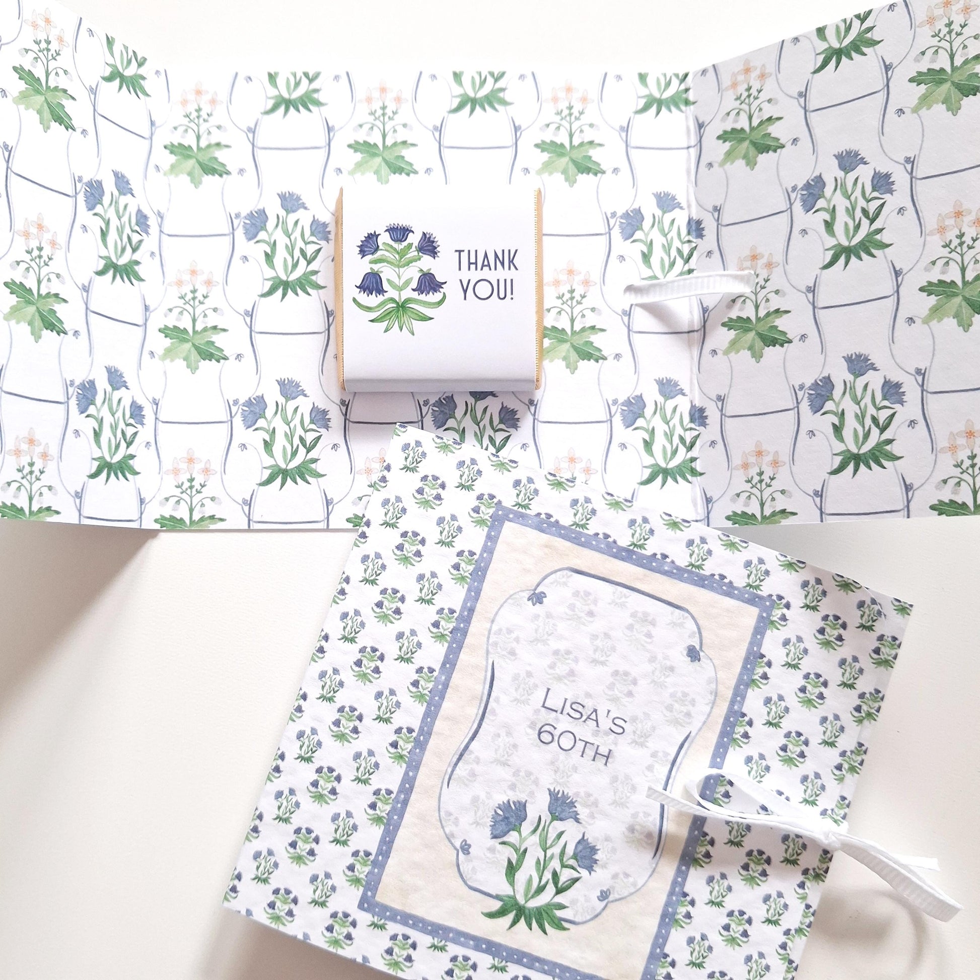  personalised milestone birthday favour, featuring floral blue designs and chocolate treats.
